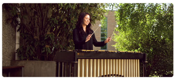 音乐ian playing percussion instrument outdoors
